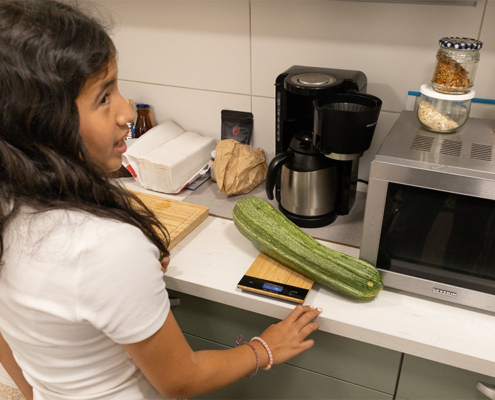 4.8.2026 // Anderthalb Kilo. 4.8.2026, die große Zucchini wird gewogen.
